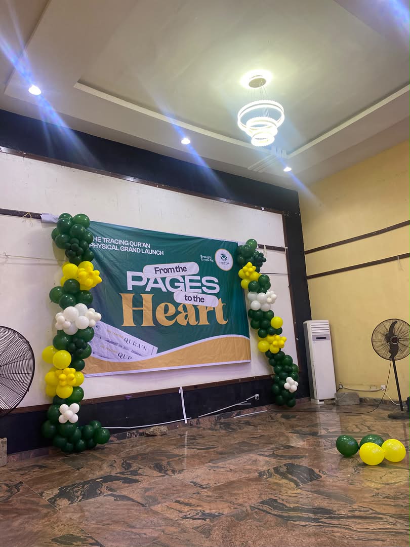 Launch venue decorated with a green and gold From the Pages to the Heart banner and balloon arch